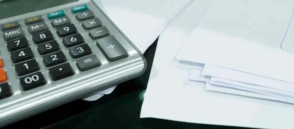 Land tax assessment form and calculator on desk with NSW property documents